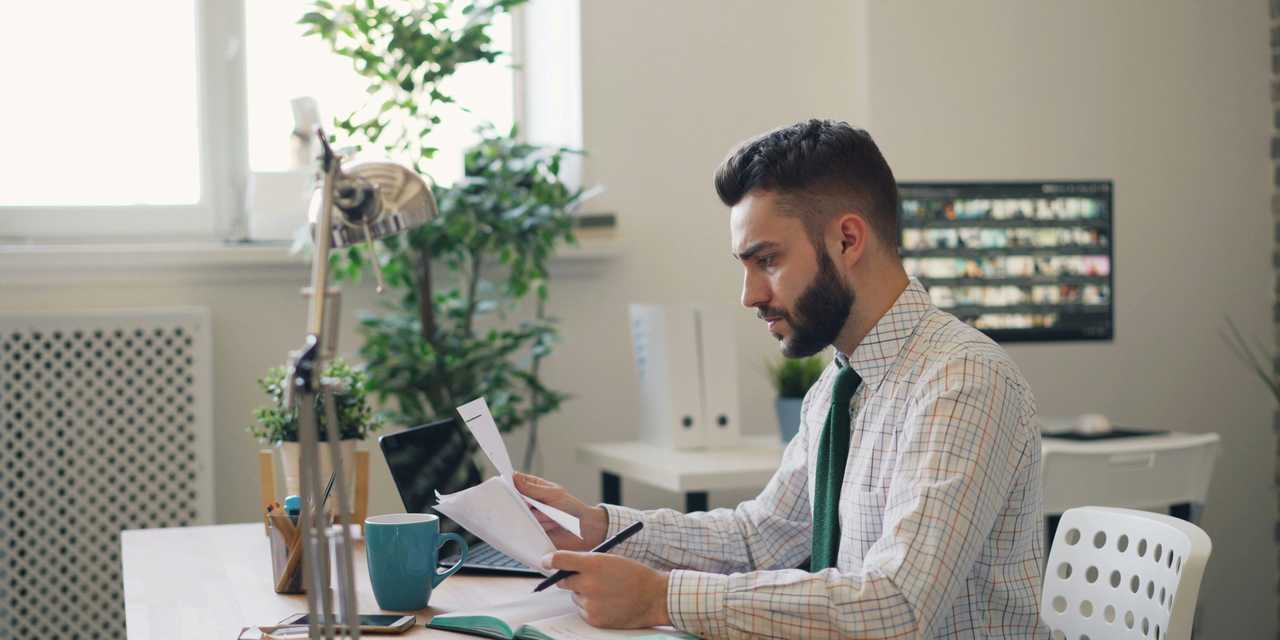 A person checking documents by the desk