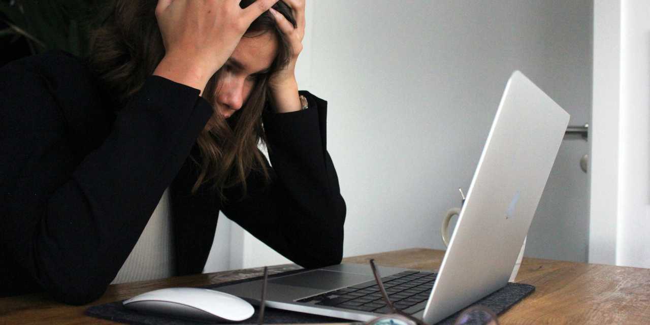 Frustrated woman in front of a laptop