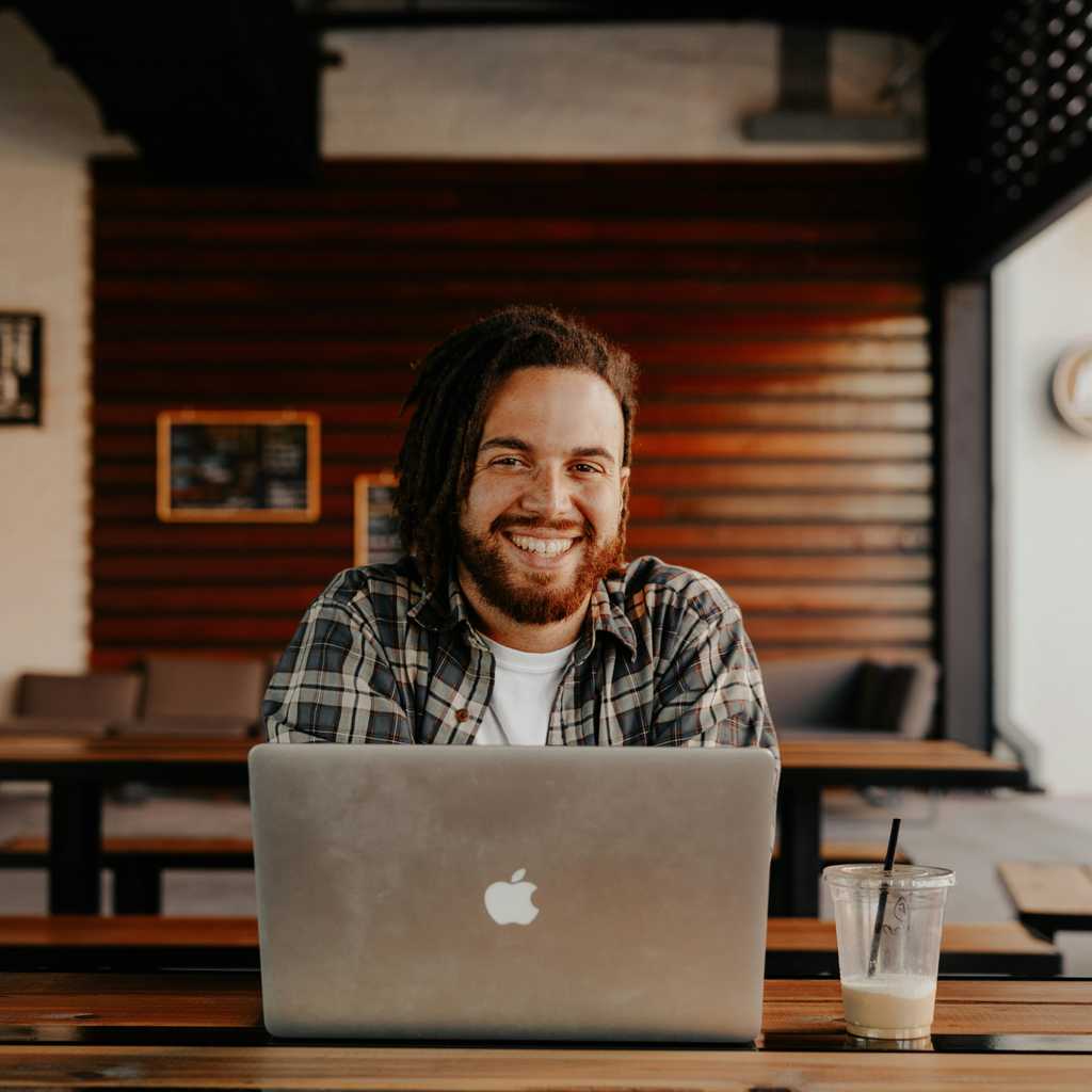 A man on a laptop in a cafe