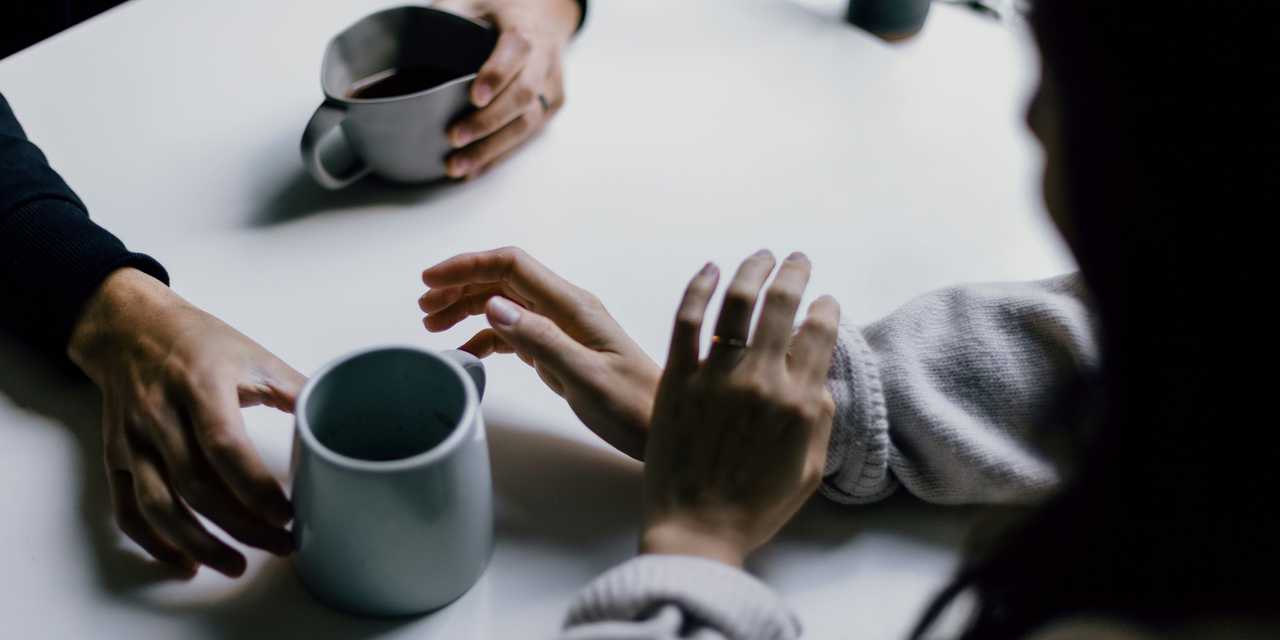 Two people talking over a cup of coffee