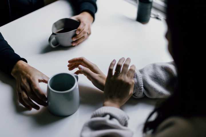 Two people talking over a cup of coffee