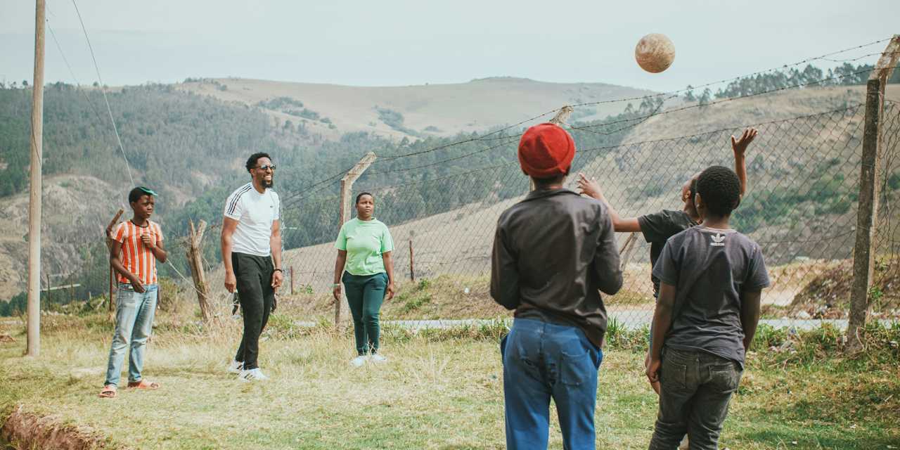 A familu playing football on a field