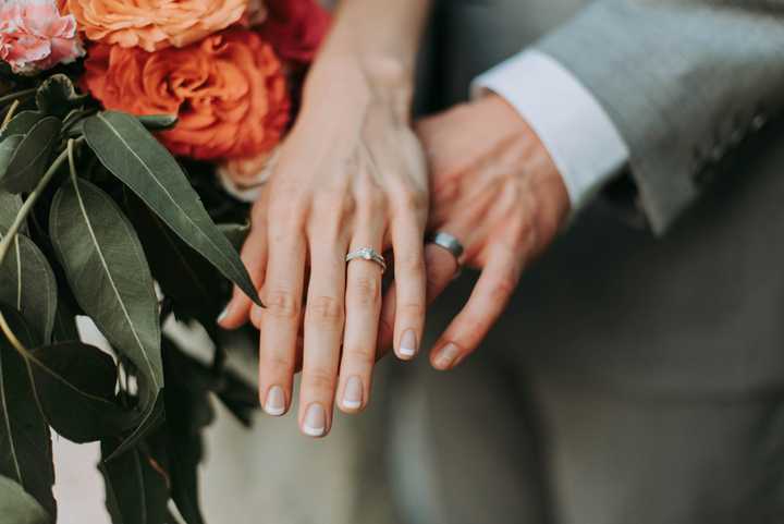 Hands showing rings and a flower bucket