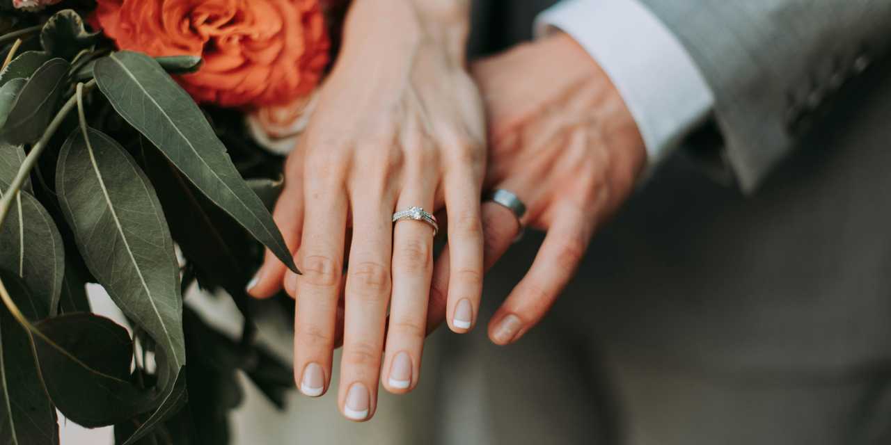 Hands showing rings and a flower bucket