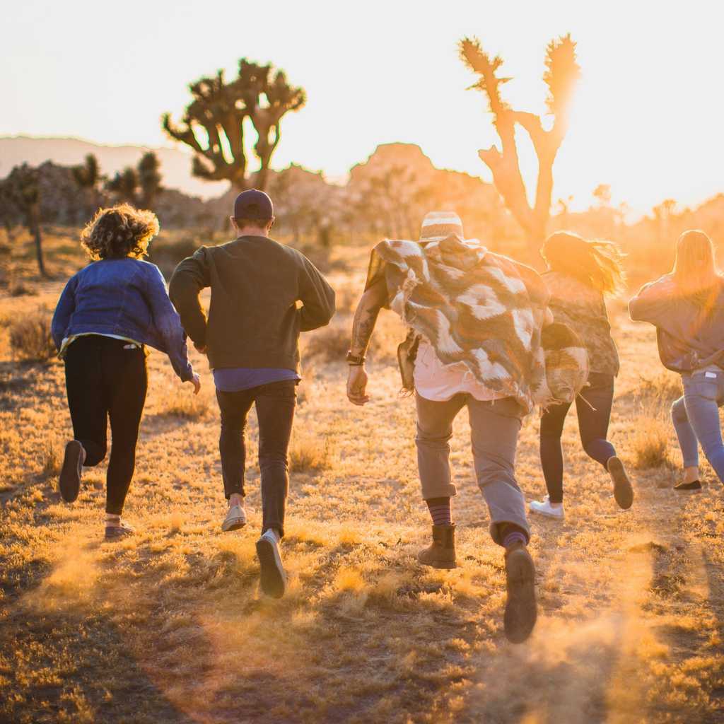 Friends running around in the desert.